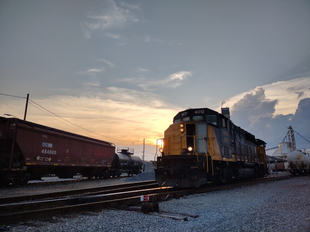 Michael H. Massey on Train Siding: WAMX 4012 awaiting orders while switching out tanks to be cleaned on a humid afternoon with storms in the distance