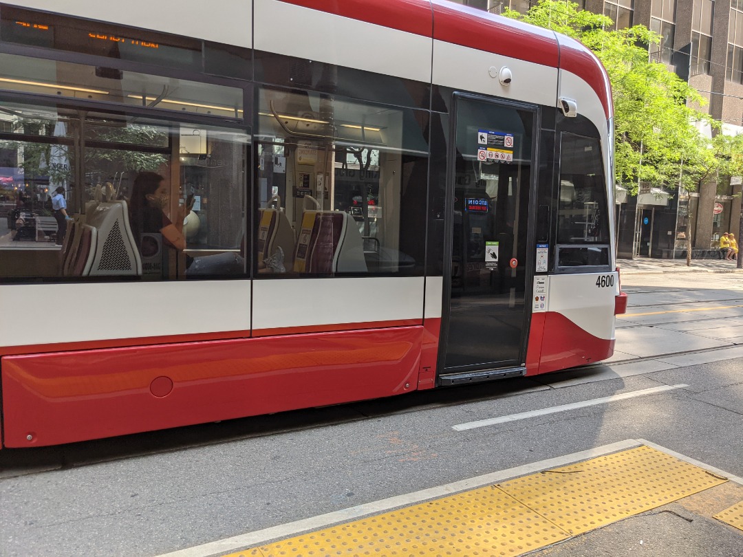 Ryan on Train Siding: Eastbound 504A King pulling up to the streetcar stop at King station. Streetcar is a Bombardier Flexity