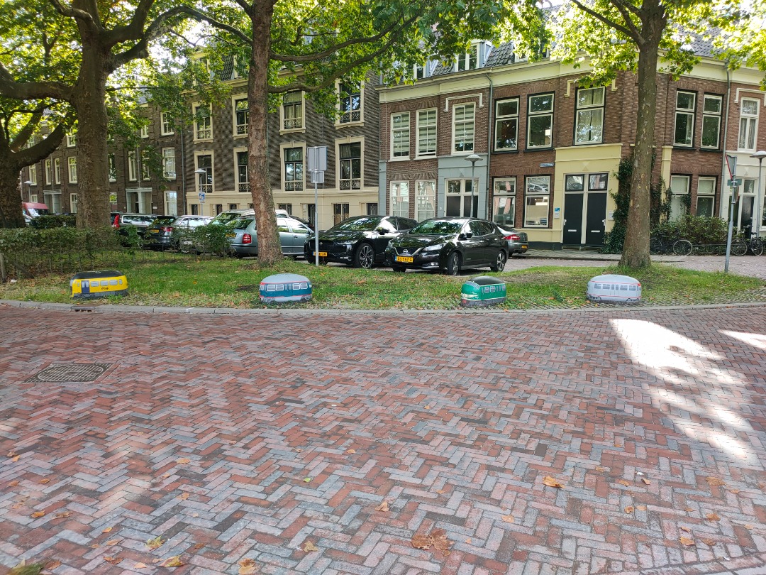 Christiaan Blokhorst on Train Siding: Some painted stones on a back street of the railmuseum. The stone prevent cars to park on the grass.