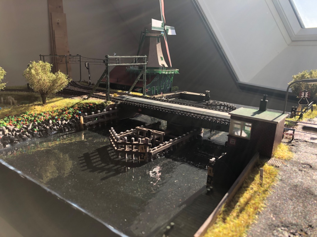 Roeland Kluit on Train Siding: The water has been poored, the overhead wires installed and most of the scenery compled. The first module is nearing completion.