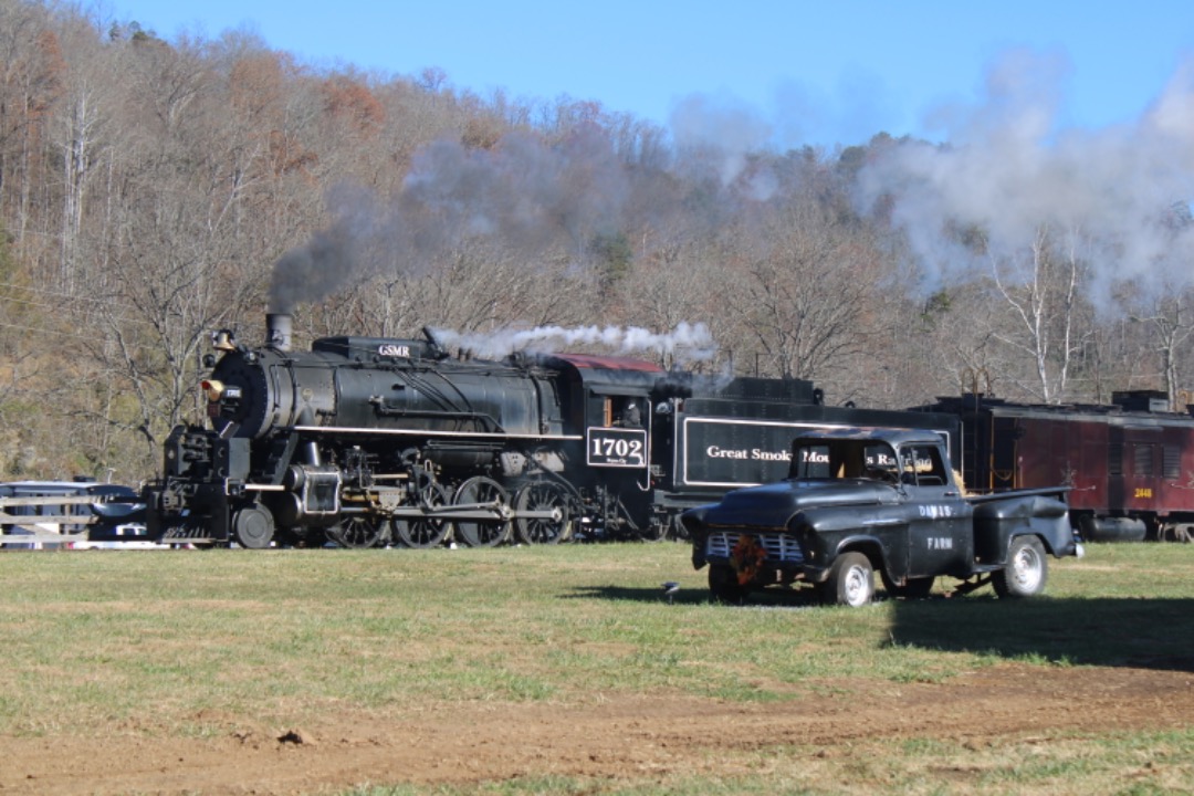 GreatSmokyMtnsRailfan on Train Siding: Great Smoky Mountains Railroad 1702 rolls past a mountain farm next to the Tuckesegee river.