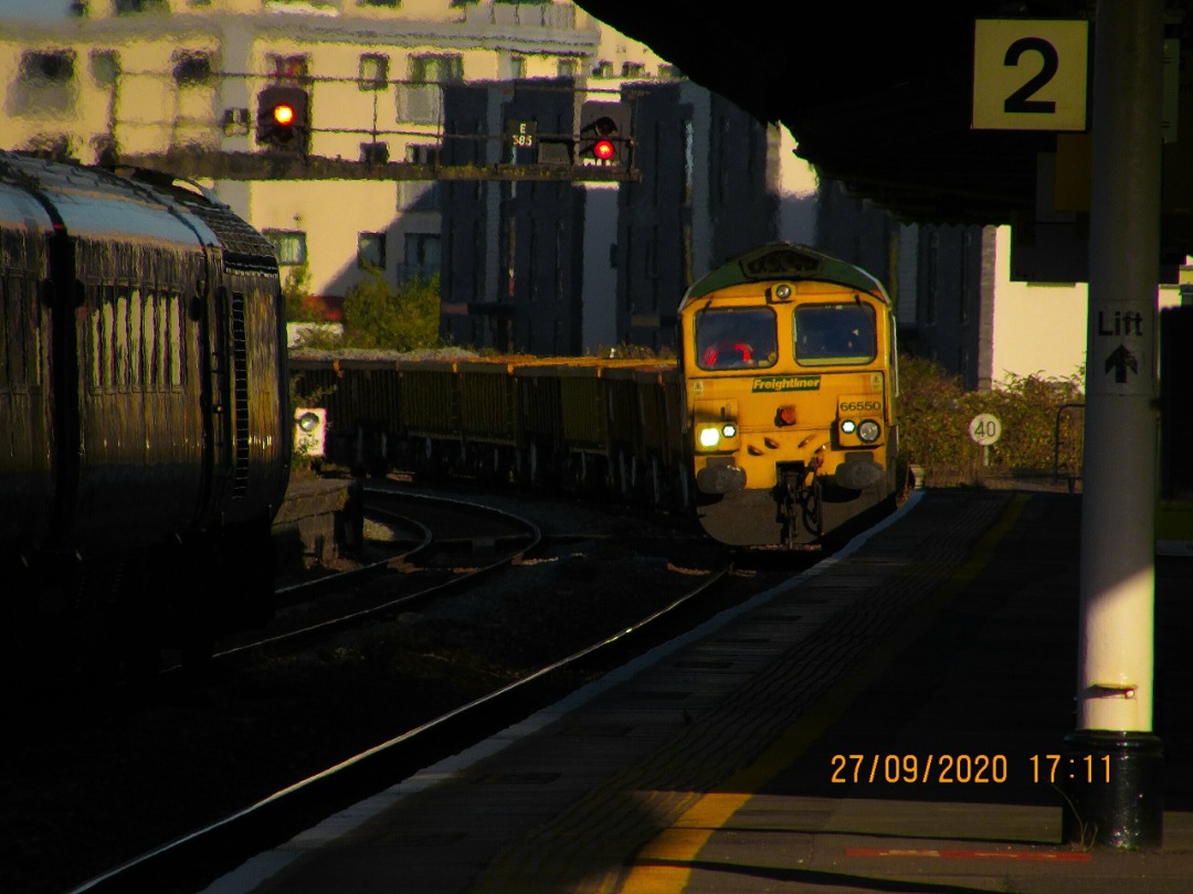 AB Rail Photography on Train Siding: Crawling it's way up to the signal, Freightliner UKs 66550 and a loaded rake of mixed ballast wagons passes through
Taunton...