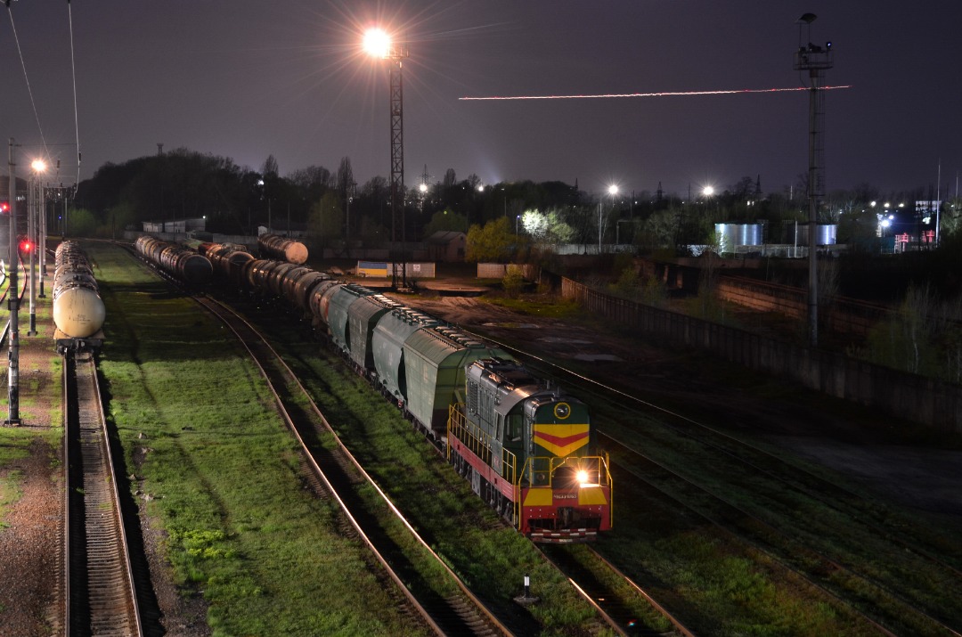 Yurko Slyusar on Train Siding: Diesel locomotive ChME3-1063 at the Boryspil station, on the background can see а strip of light of the plane which has landing
to the...