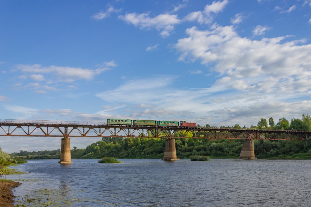 CHS200-011 on Train Siding: Diesel locomotive TU7A-3322 travels with the Karintorf - Kirovo-Chepetsk commuter train across the bridge over the Cheptsa River.
This...