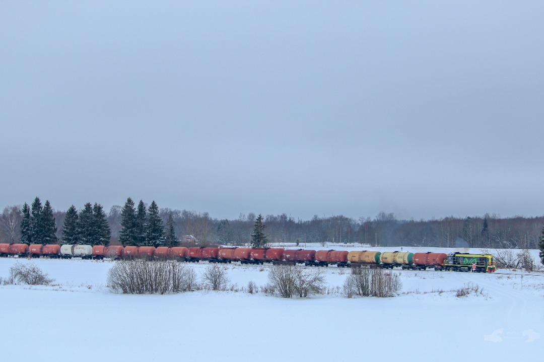 Adam L. on Train Siding: An Enefit owned TEM2 switcher, numbered 8390 is captured in frame with a short string of empty tank cars, is seen slowly reaching
it's...