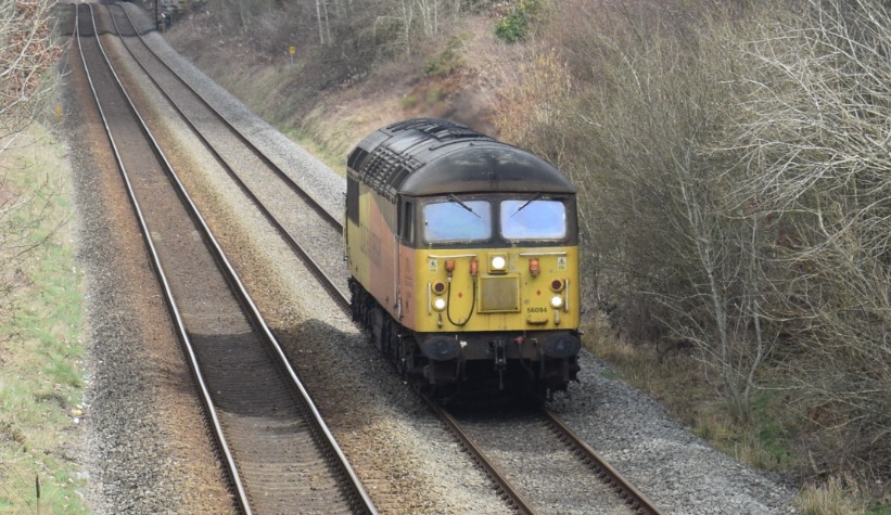 Hardley Distant on Train Siding: CURRENT: 56094 passes Rhosymedre near Ruabon today with the 0Z54 10:54 Bescot Up Engineers Sidings to Chirk Kronospan Light
Engine...