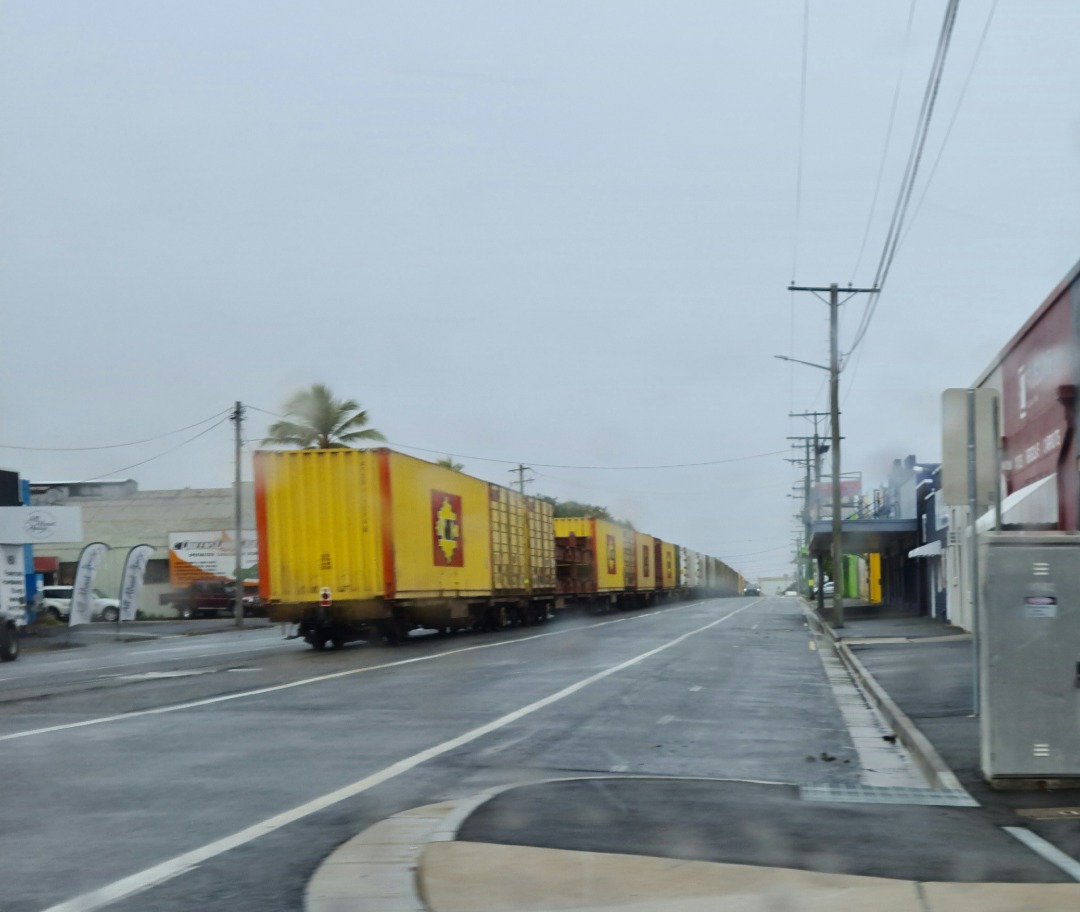 Geoff on Train Siding: Linfox freighter heading south into Rockhampton yard on Denison St on a rainy day. Linfox own the train with Aurizon providing hook and
pull...