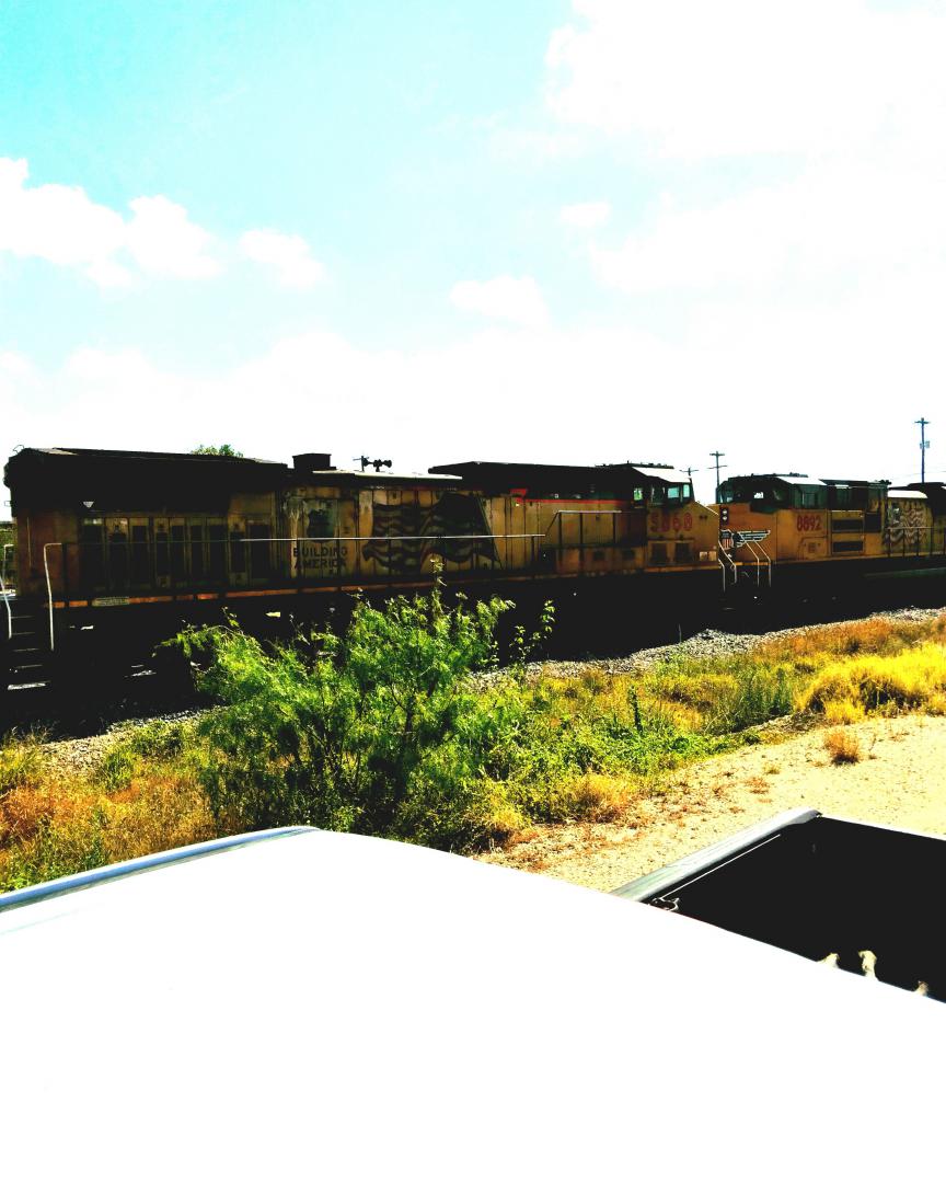 Robert Wiley on Train Siding: UP6715, UP8660, UP5868, UP8892 lead an eastbound intermodel pull to a stop at CP T405 Holder in Abilene, TX to allow a chasing
train to...