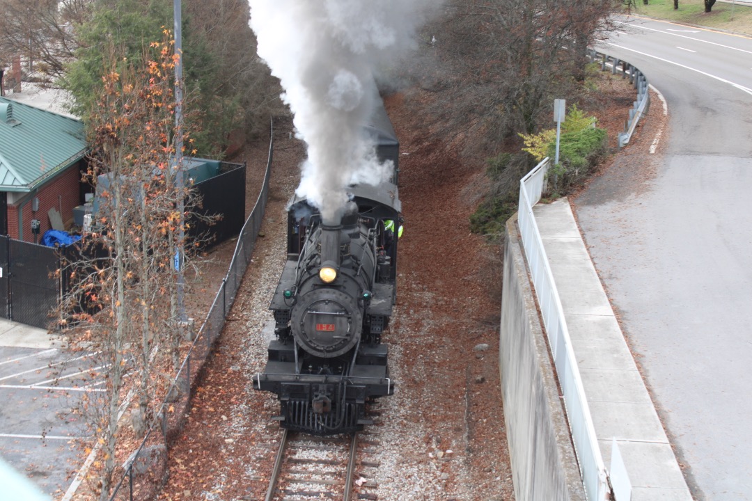 GreatSmokyMtnsRailfan on Train Siding: Southern 154 passes under a walking bridge in downtown Knoxville, Tennessee with the Three Rivers Rambler.