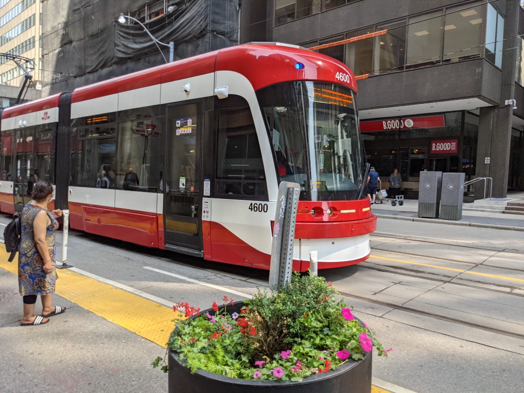 Ryan on Train Siding: Eastbound 504A King pulling up to the streetcar stop at King station. Streetcar is a Bombardier Flexity