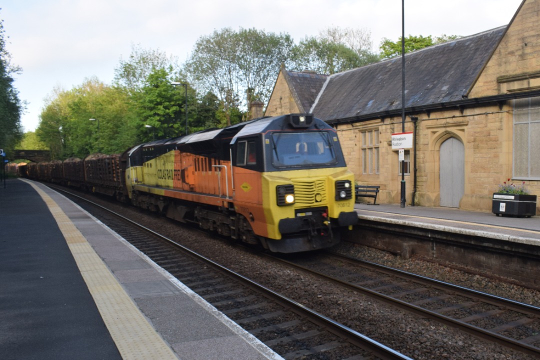Hardley Distant on Train Siding: CURRENT: 70812 passes through Ruabon Station today with the 6J37 12:52 Carlisle Yard to Chirk Kronospan Logs service.