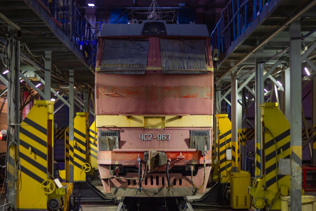 CHS200-011 on Train Siding: electric locomotive CHS2T-963 in the workshop of the service locomotive depot undergoes TO-5V (maintenance of the locomotive, which
arrived...