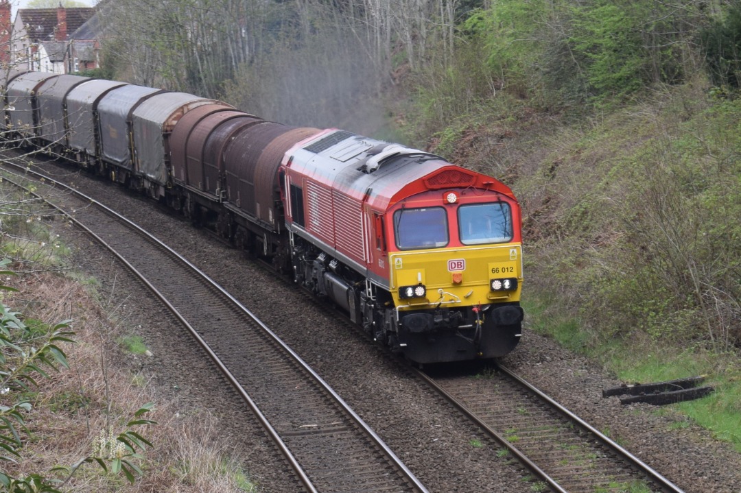 Hardley Distant on Train Siding: CURRENT: 66012 approaches Ruabon Station today with the 6V75 09:31 Dee Marsh Reception to Margam Terminal Complex empty Steel
service.