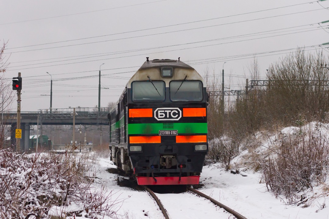 CHS200-011 on Train Siding: The freight diesel locomotive of the company "BaltTranService" 2TE116U-0192 is warming up at the Avtovo station