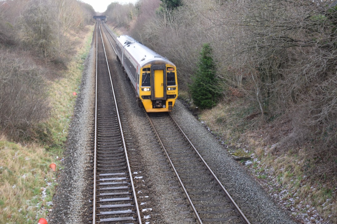 Hardley Distant on Train Siding: CURRENT: 158825 passes Rhosymedre near Ruabon roday with the 1I18 Holyhead to Birmingham International (Transport for Wales)
service.