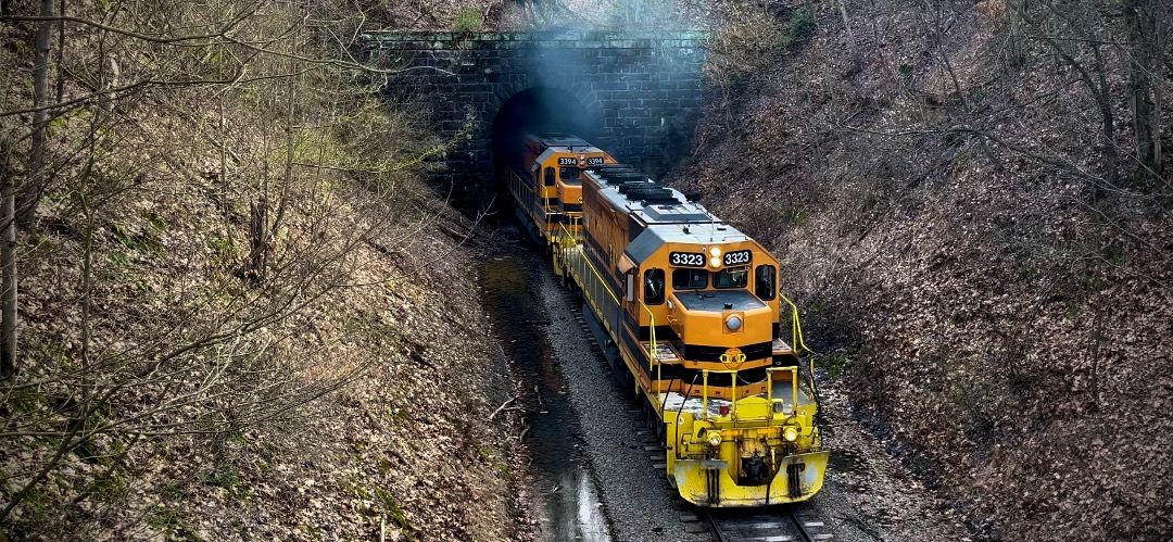Ravenna Railfan 4070 on Train Siding: G&W BTRI emerges from an old tunnel with G&W SD40-2 # 3233 an ex CNW unit equipped with a gong bell