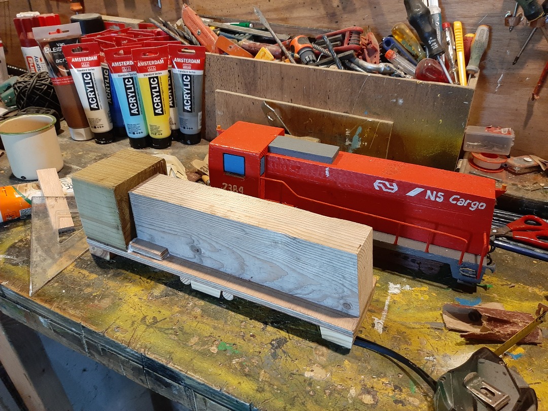 RRail on Train Siding: The loco is made of an old garden pole and some timber left overs. The fences are made of old iron bits and pieces. The waggons are made
of some...