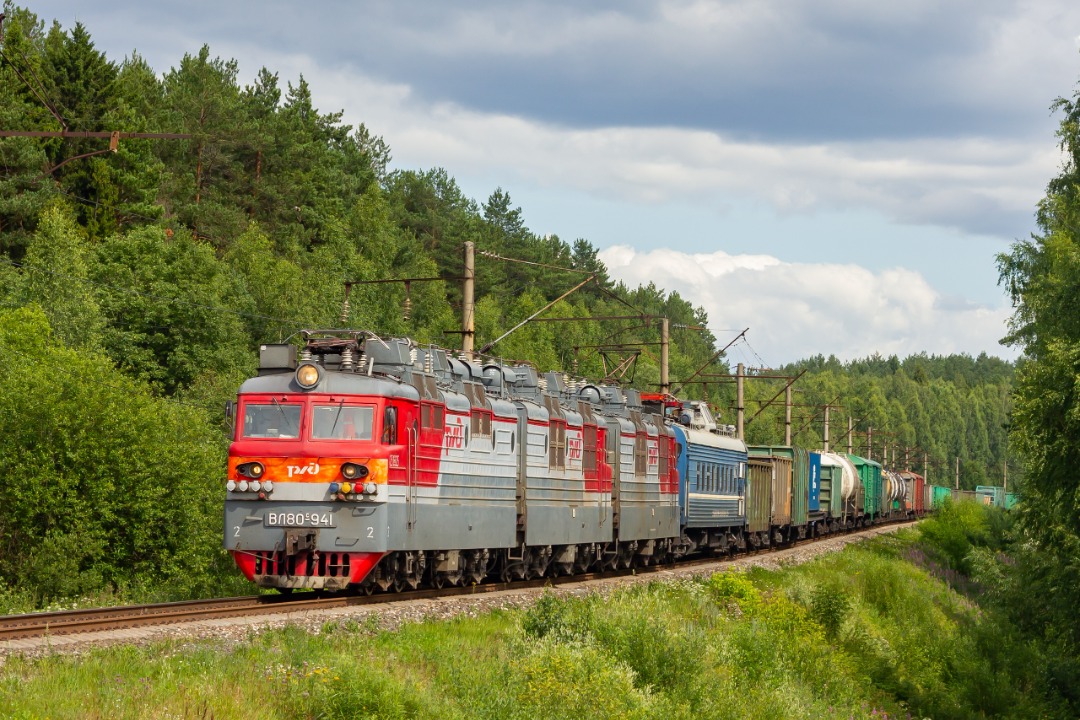 CHS200-011 on Train Siding: The photo shows the electric locomotive VL80S-941 with a freight train at the Bumkombinat station.