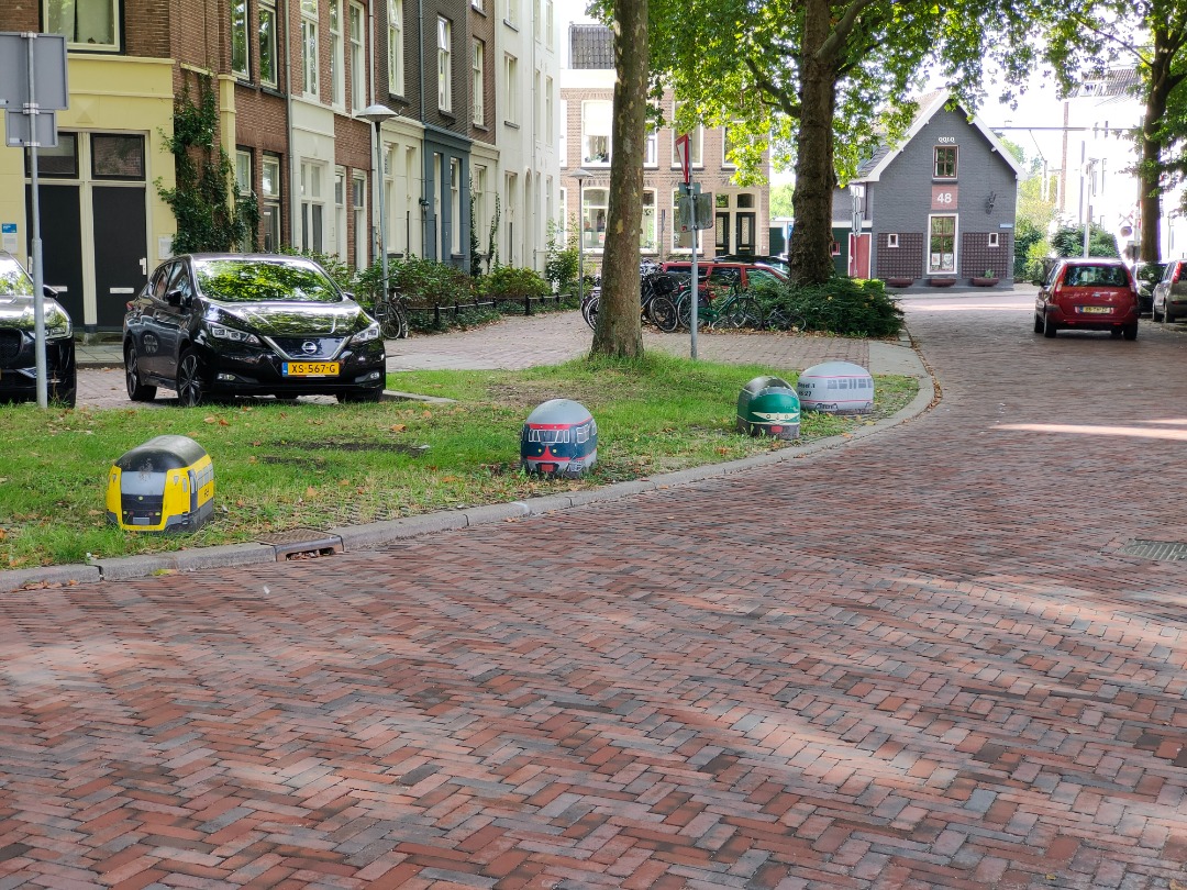 Christiaan Blokhorst on Train Siding: Some painted stones on a back street of the railmuseum. The stone prevent cars to park on the grass.