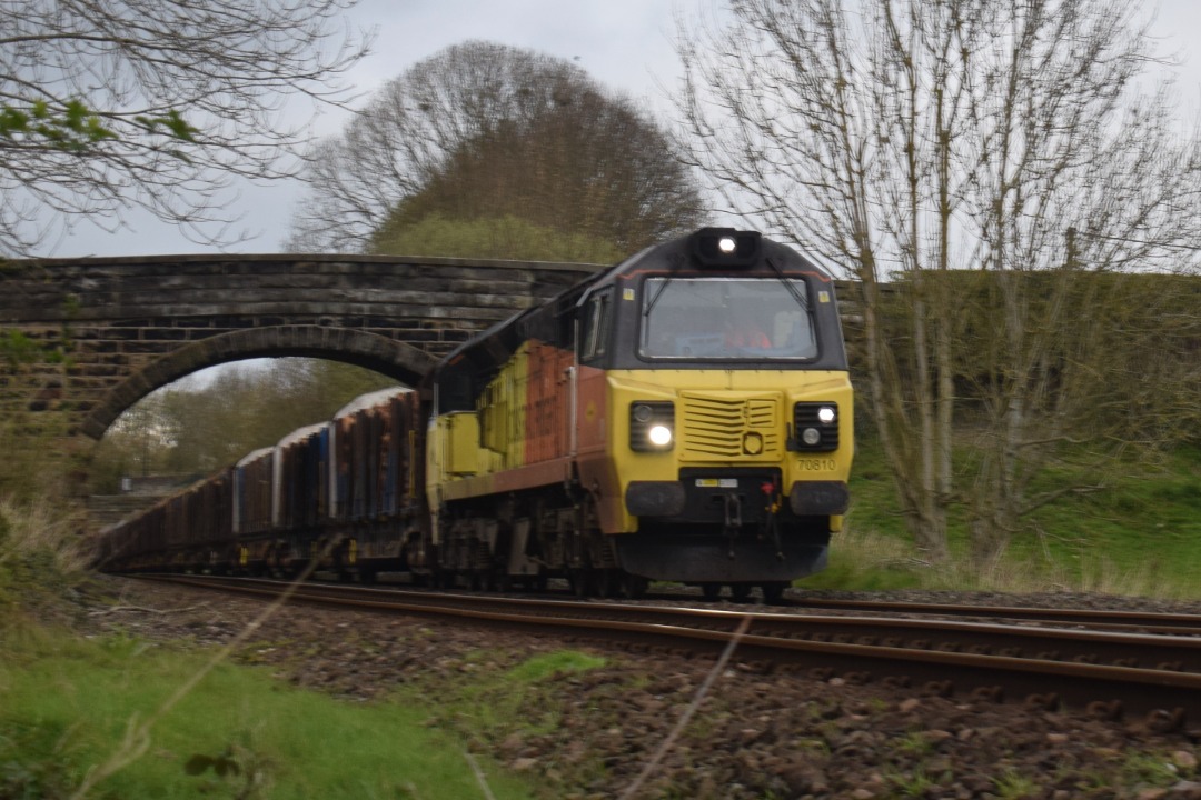Hardley Distant on Train Siding: CURRENT: 70810 passes Pentre between Chirk and Ruabon today with the 6J37 12:52 Carlisle Yard to Chirk Kronospan Logs service.